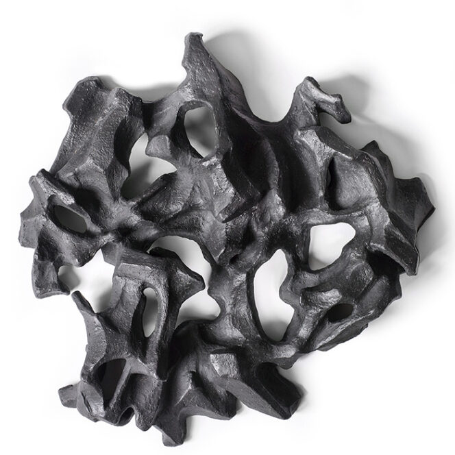 Black, abstract wall sculpture made of stoneware