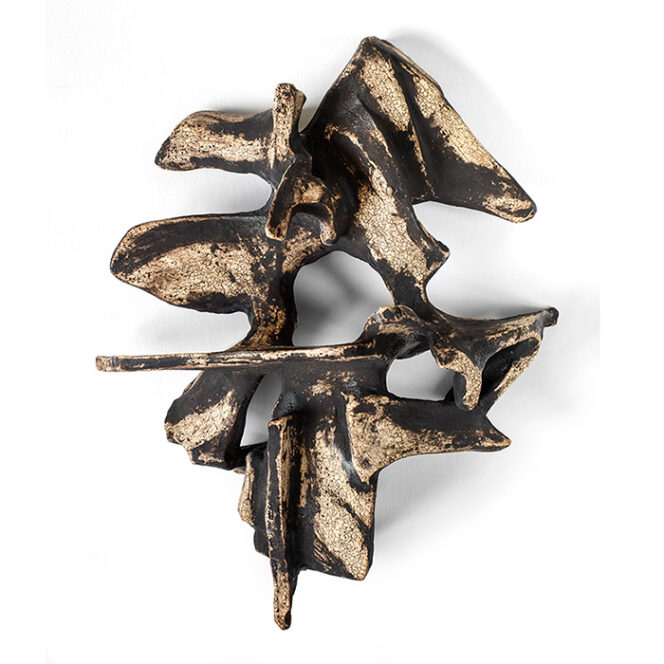 Tan and black abstract wall sculpture made of stoneware