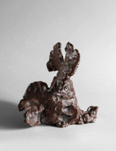 Hand-built red stoneware sculpture with pinched texture and organic form.