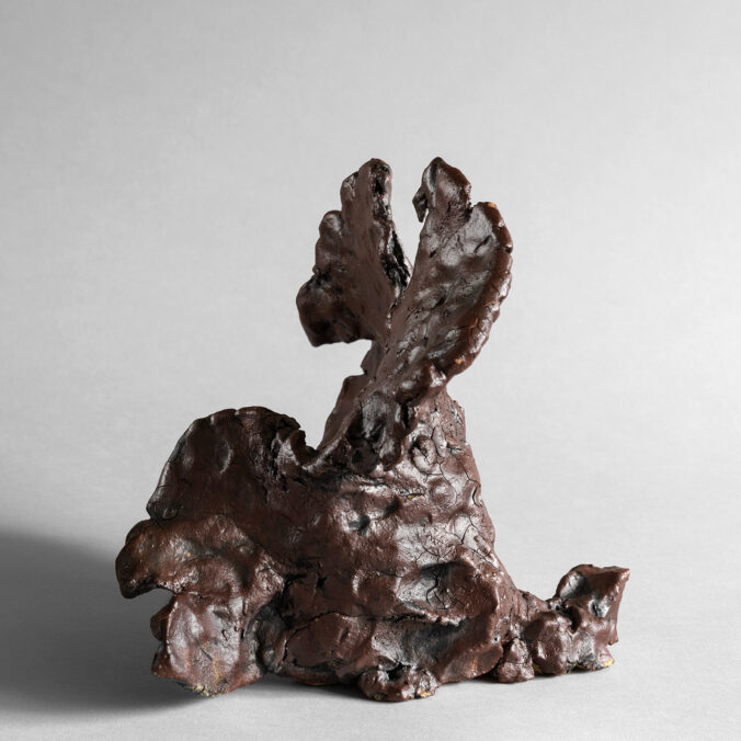 Hand-built red stoneware sculpture with pinched texture and organic form.
